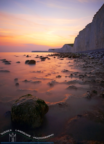 slides/Sunset Reflection.jpg sussex east birling.gap beach pools tide ocean coast beachy head lighthouse eastbourne rocks water ocean people person clouds storm cliffs pebbles red white blue seven sisters country park moon cresent ripples sand Sunset Reflection